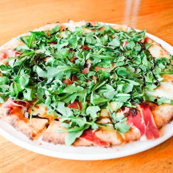 A Cleveland Park Bar & Grill pizza topped with prosciutto, mozzarella, arugula, and balsamic glaze.